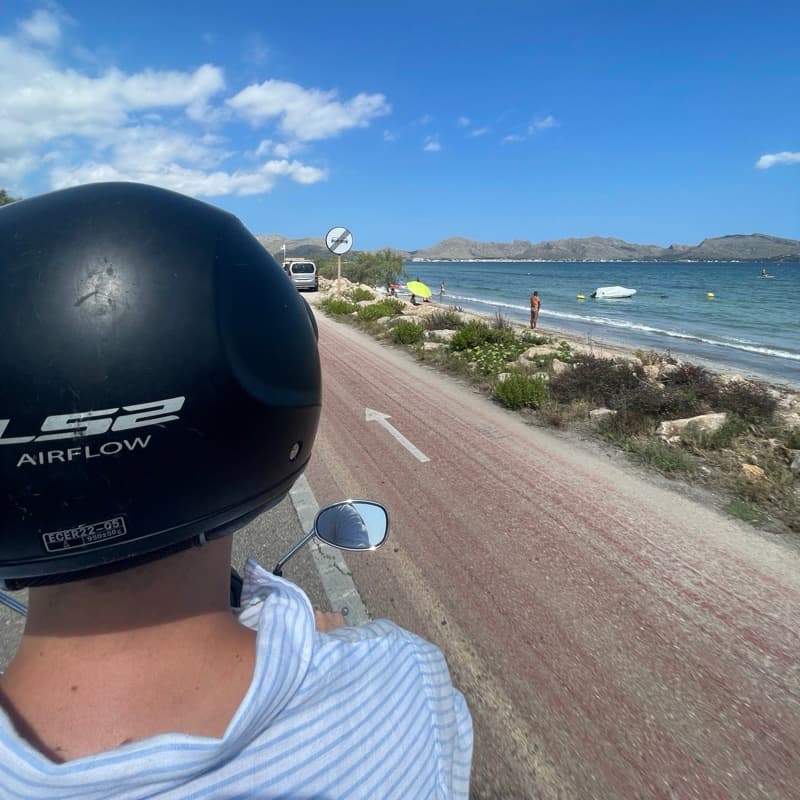 Riding a scooter along the coast